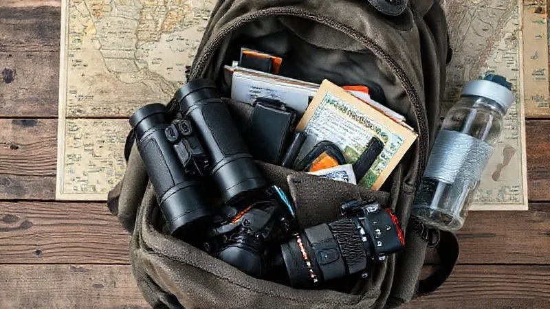 A photorealistic image of a neatly organized backpack with essential birdwatching gear: high-quality binoculars, a field guide, a small notebook, a camera with a telephoto lens, and a water bottle, all laid out on a rustic wooden table with a map in the background. Cinematic lighting, sharp focus, 8K, professional photography. A photorealistic image of a neatly organized backpack with essential birdwatching gear: high-quality binoculars, a field guide, a small notebook, a camera with a telephoto lens, and a water bottle, all laid out on a rustic wooden table with a map in the background. Cinematic lighting, sharp focus, 8K, professional photography.