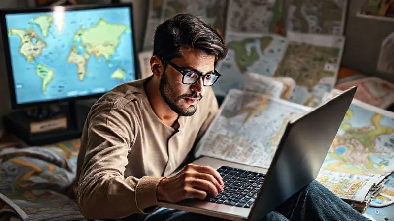 A photorealistic image of a person sitting in front of a laptop, surrounded by travel guides and maps, with a focused expression, researching sustainable travel destinations. The screen shows a map with green markers in less-known locations. Cinematic lighting, sharp focus on the person and screen, depth of field blurring the background. 8K hyper-detailed, professional photography, shot on a high-end DSLR. A photorealistic image of a person sitting in front of a laptop, surrounded by travel guides and maps, with a focused expression, researching sustainable travel destinations. The screen shows a map with green markers in less-known locations. Cinematic lighting, sharp focus on the person and screen, depth of field blurring the background. 8K hyper-detailed, professional photography, shot on a high-end DSLR.